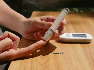Photo by isens usa a person sitting at a table with a cell phone
